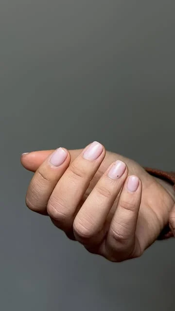 Unhas nude rosadas com um ponto minimalista